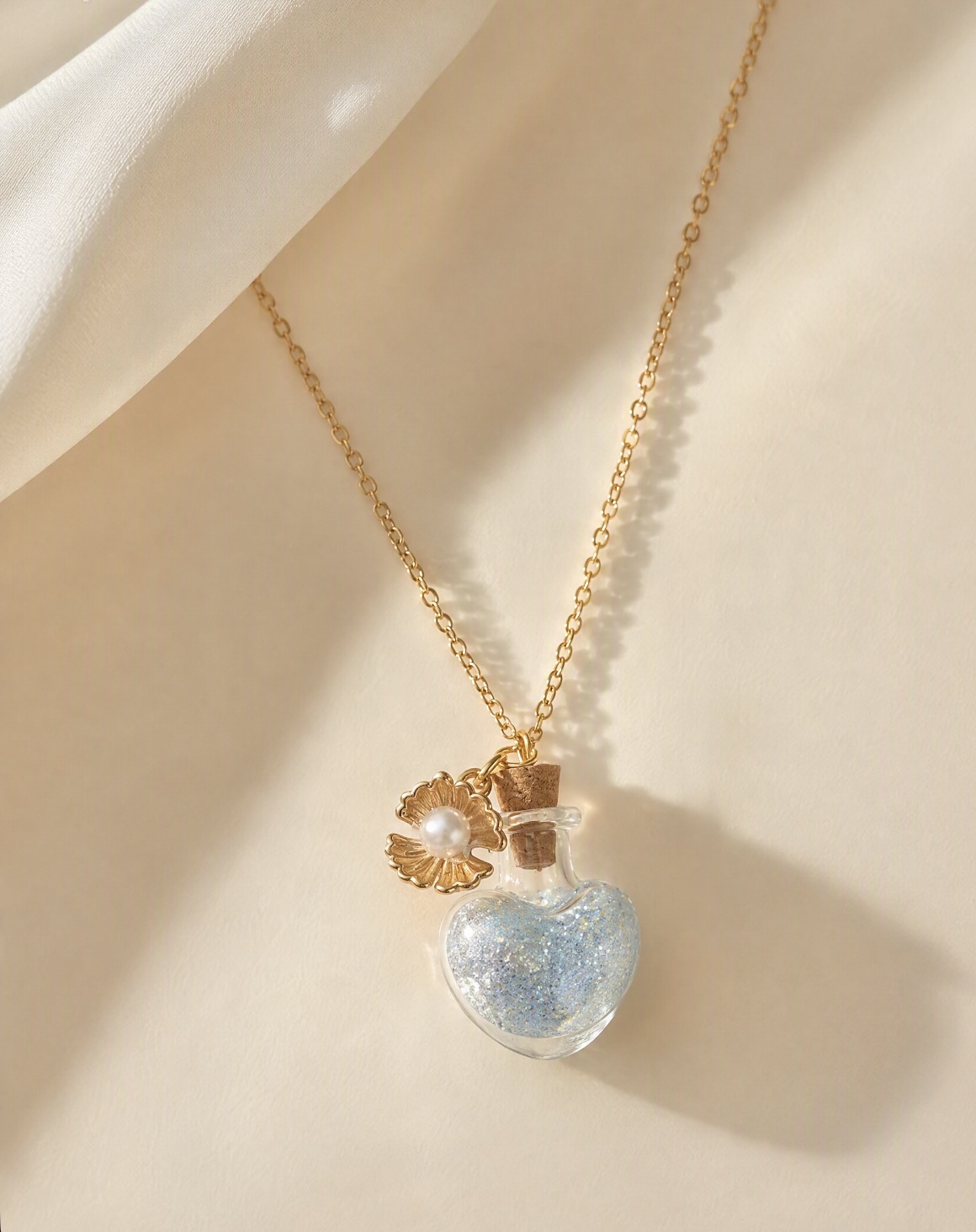 Gold heart bottle necklace with shimmer glitter